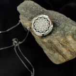 Srebrny naszyjnik z motywem słońca na kamieniu, elegancki styl.