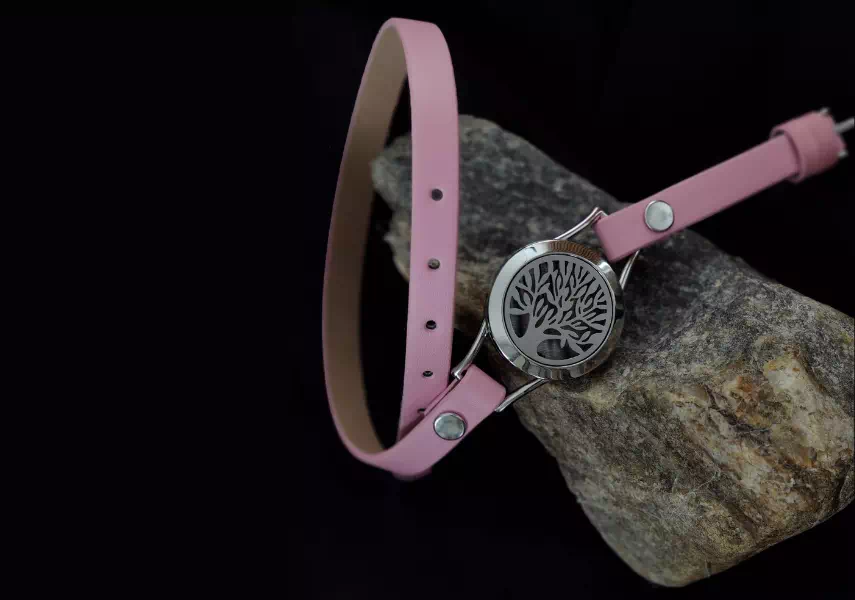 Bransoletka wykonana przez QMaćNać owijana wokół nadgarstka, różowa ekoskóra, motyw drzewa.